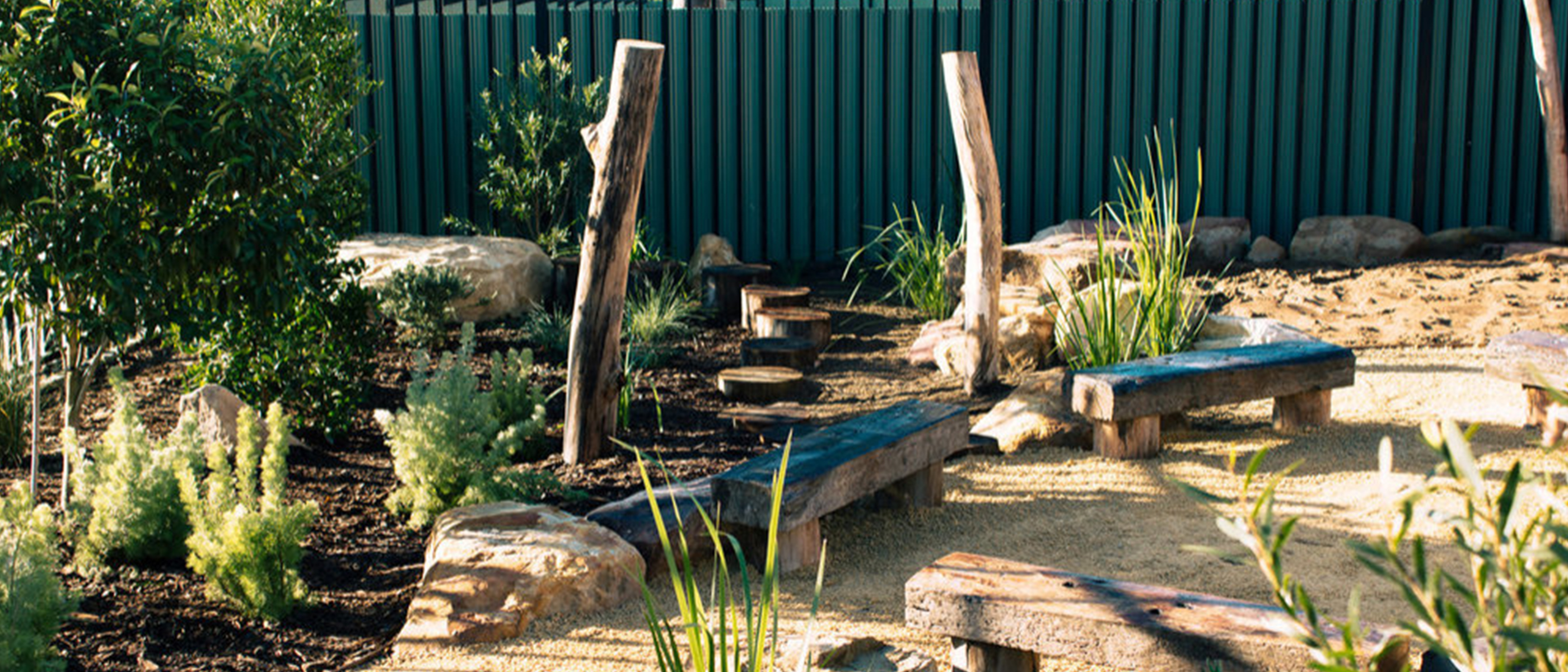 Decomposed granite pathway and native planting with stepping logs
